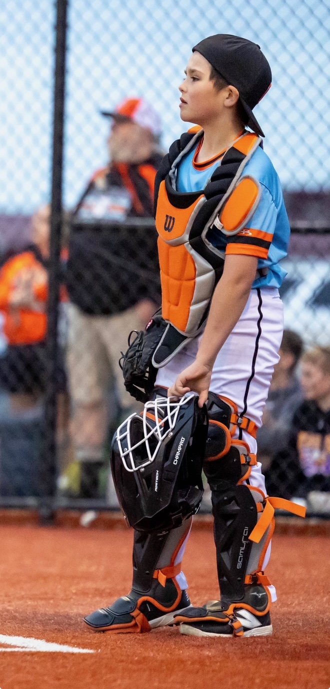 Youth baseball athlete in catcher gear